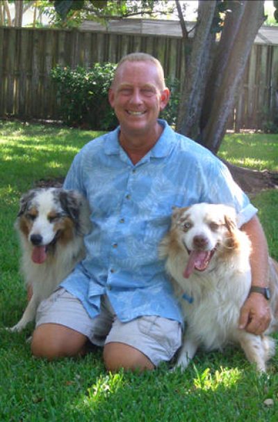 will thomas dog trainer sitting with two dogs